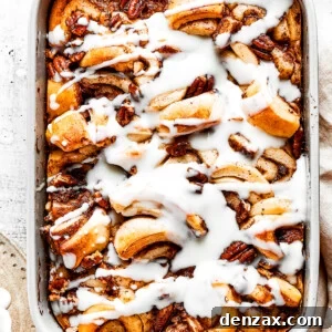 Cinnamon Roll Casserole Breakfast Bake Recipe 3 Overhead view of a cinnamon roll casserole in a baking dish, covered in icing