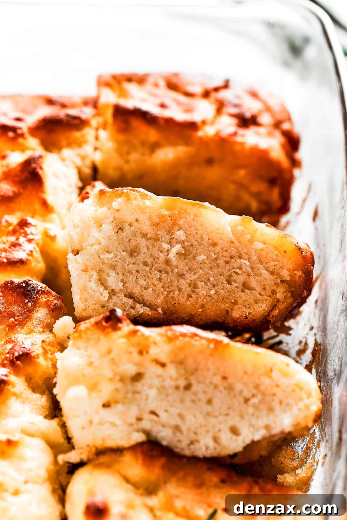 A pan with butter swim biscuits, with a few cut out and stacked on each other.