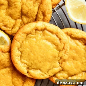 Close-up shot of several lemon cookies arranged on a round wire rack.