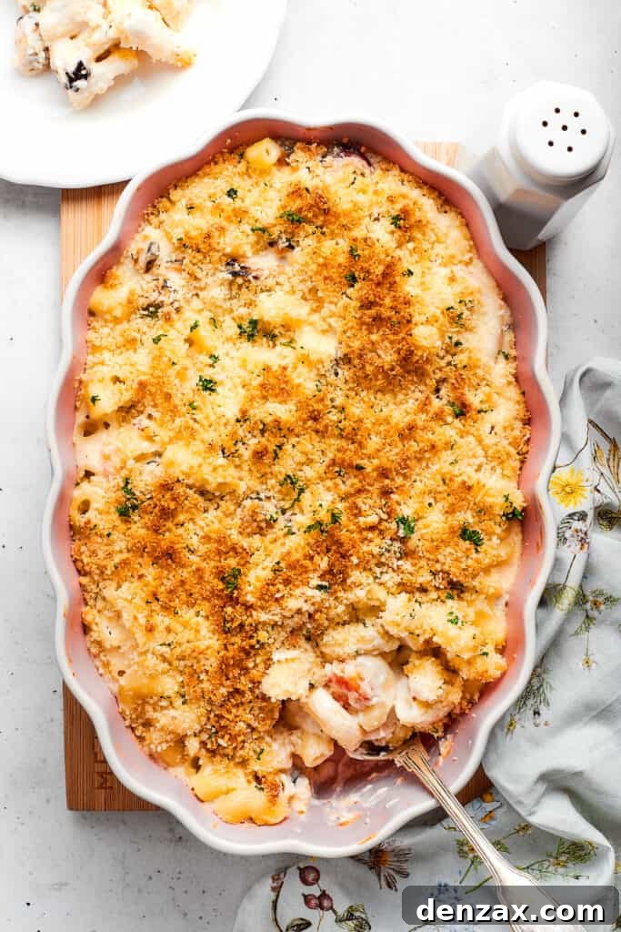Finished seafood mac and cheese Cooked Seafood mac and cheese with a serving spoon ready to take some out.
