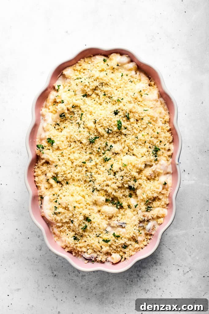 Topped and ready to bake Seafood mac and cheese topped with parmesan breadcrumbs ready to go in the oven.