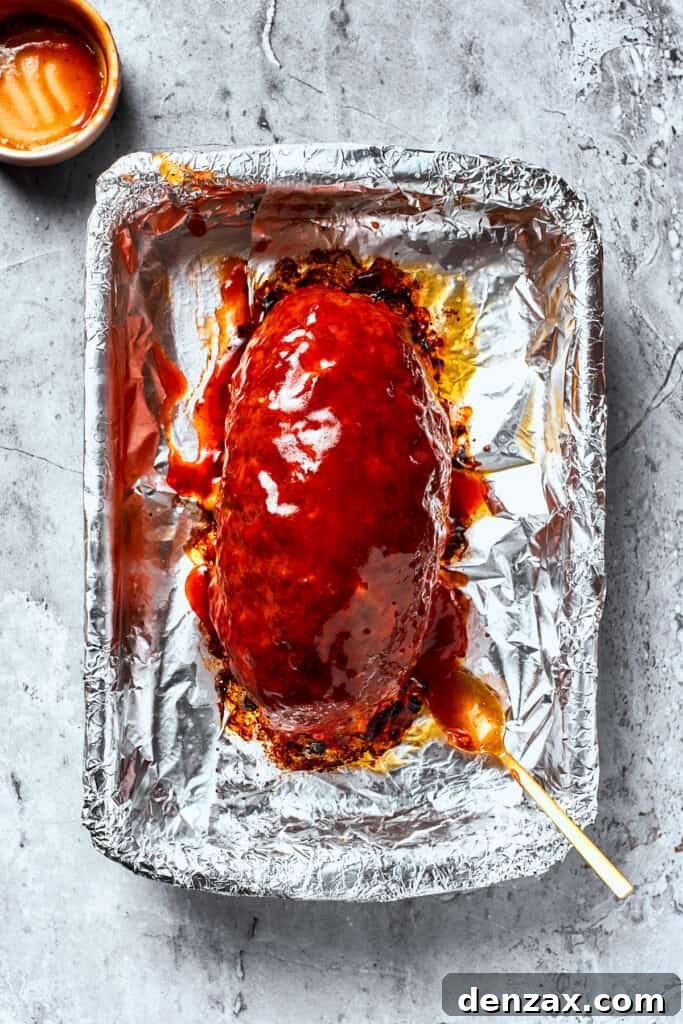 A meatloaf is topped with brown sugar glaze.