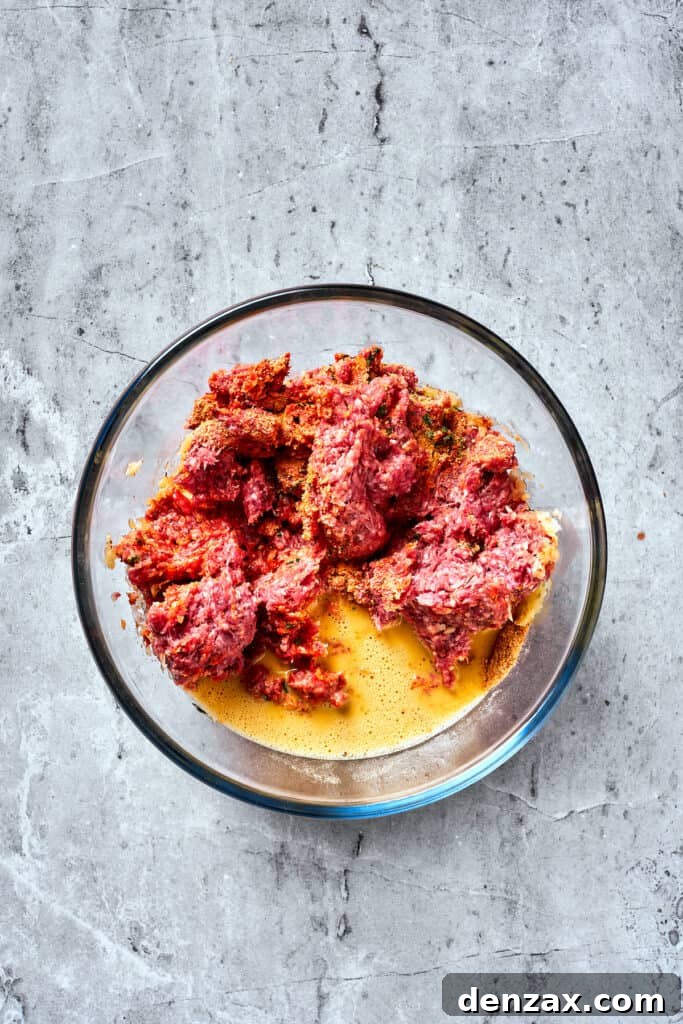 Eggs are mixed into a meatloaf base.