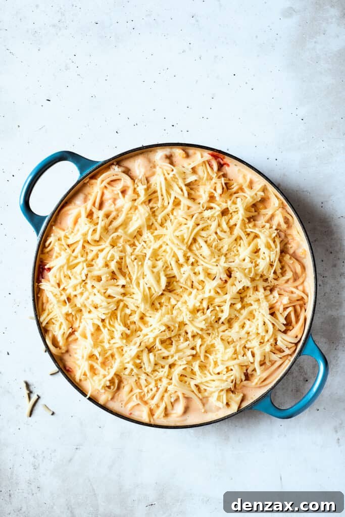 Mozzarella scattered over the pot of pasta.