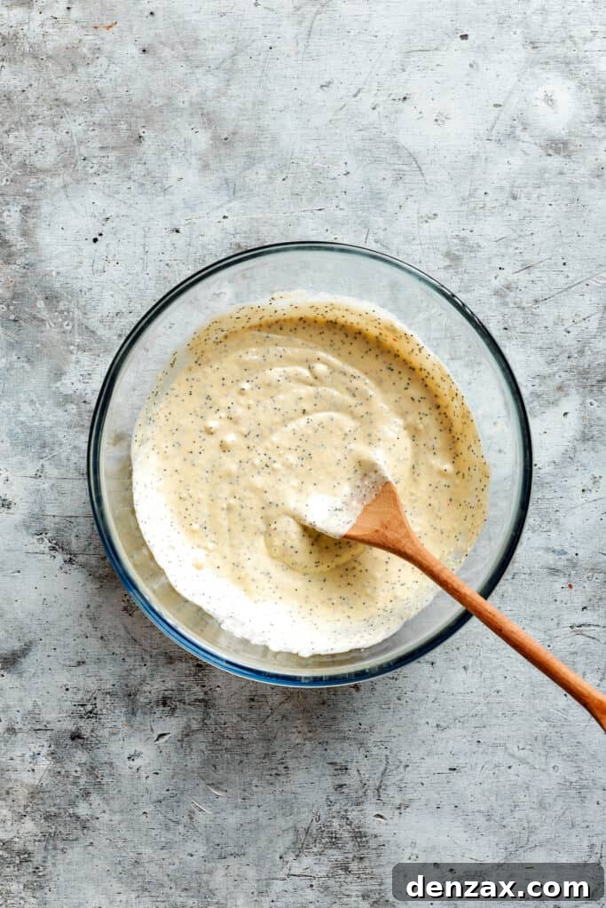 Stir until smooth and evenly combined. A wooden spoon stirs the sauce together.