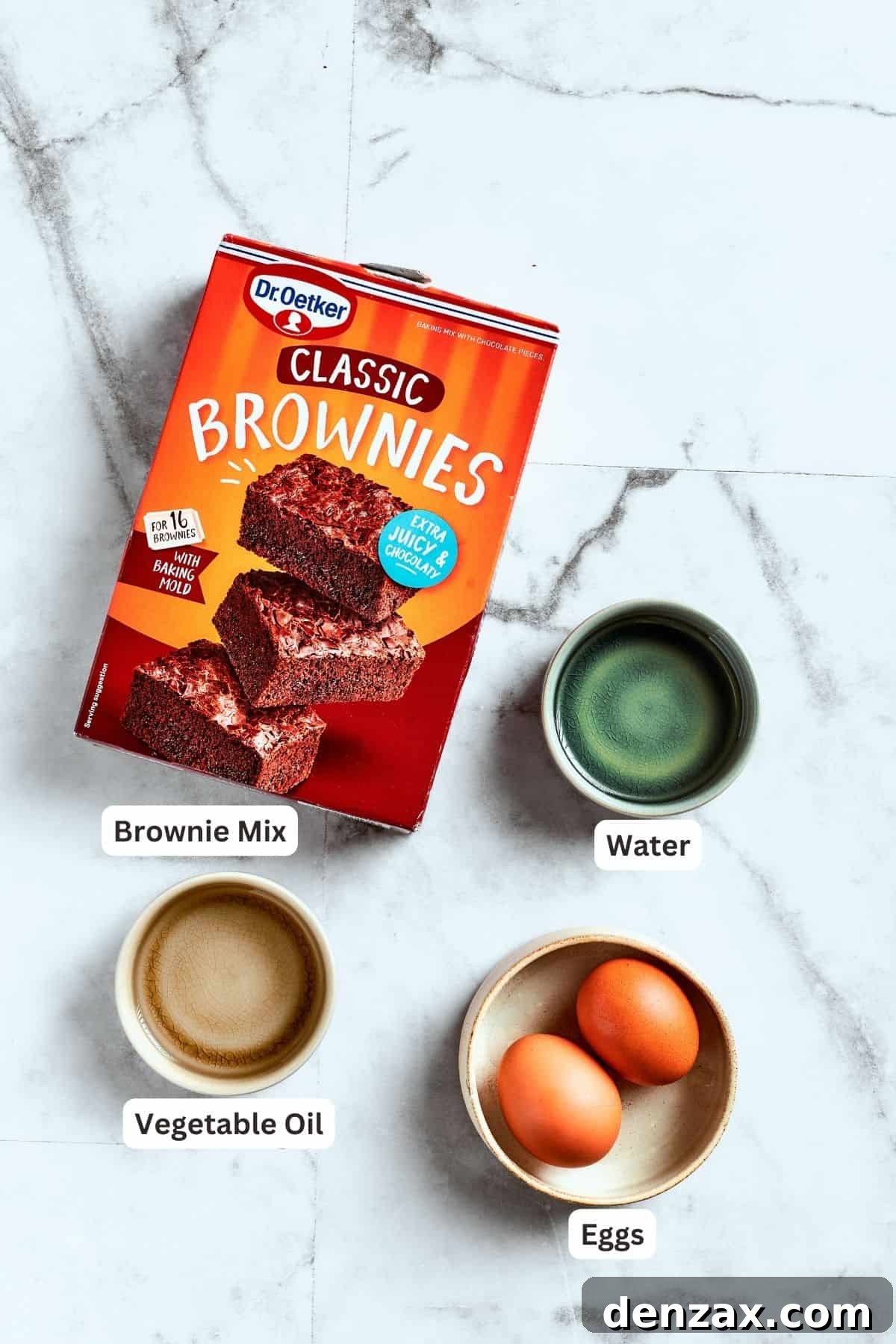 The ingredients for pecan pie brownies are shown: brownie mix, eggs, water, oil.