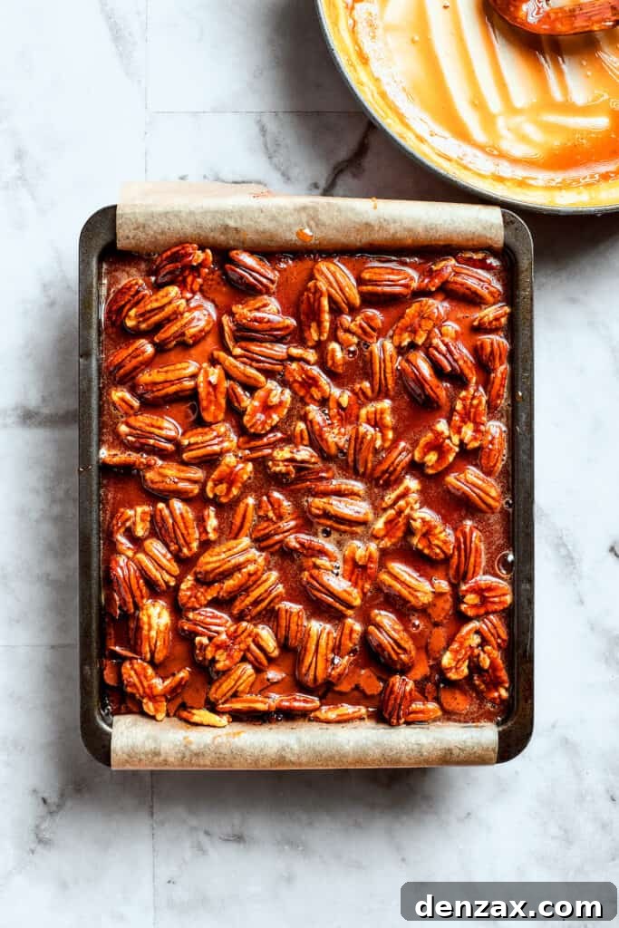 The pecan pie filling is added to the top of the brownies.