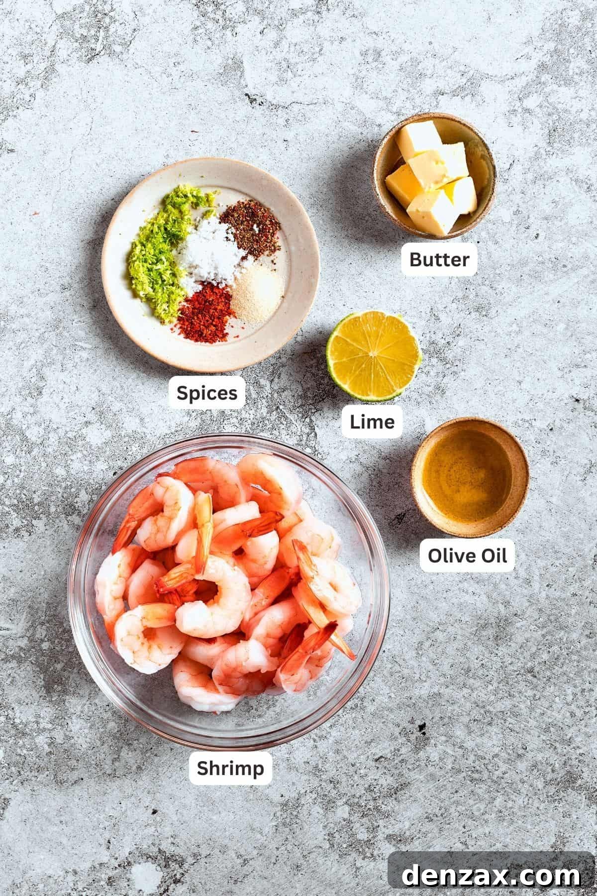 The ingredients for the shrimp are shown: shrimp, spices, butter, lime, olive oil.