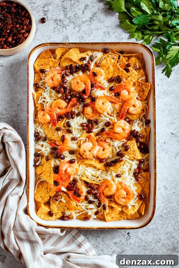 Toppings are scattered over the top of the nachos.