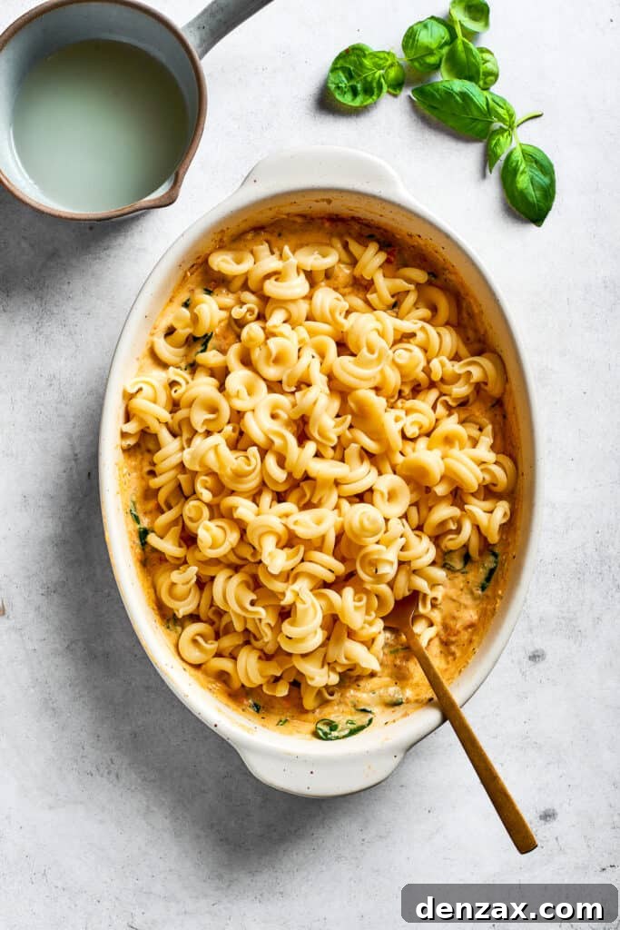 Pasta is stirred into the casserole.