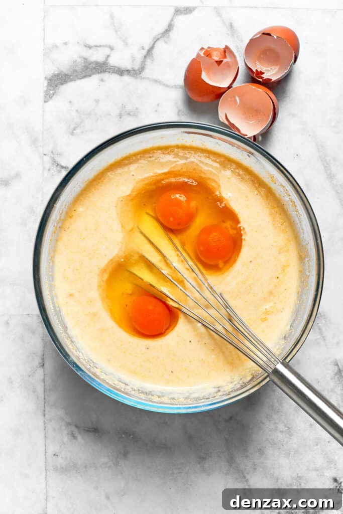 Eggs are whisked into the batter.