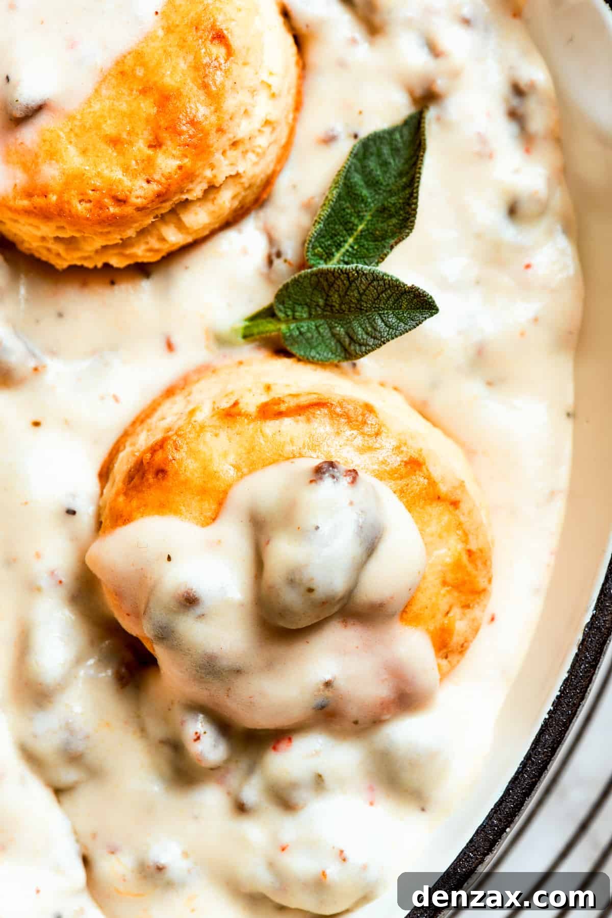 Close-up image of biscuits topped with sausage gravy.