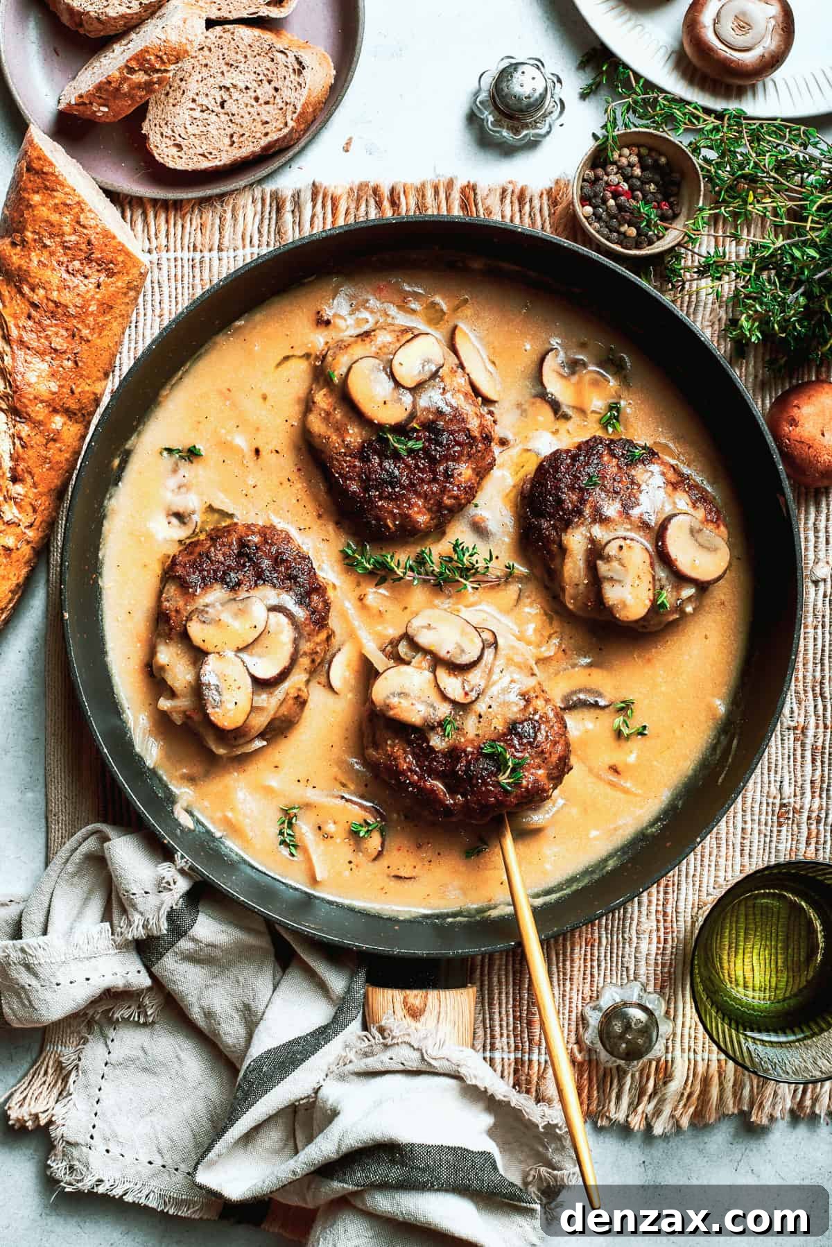 Four pieces of chopped steak are added to a pan with gravy.