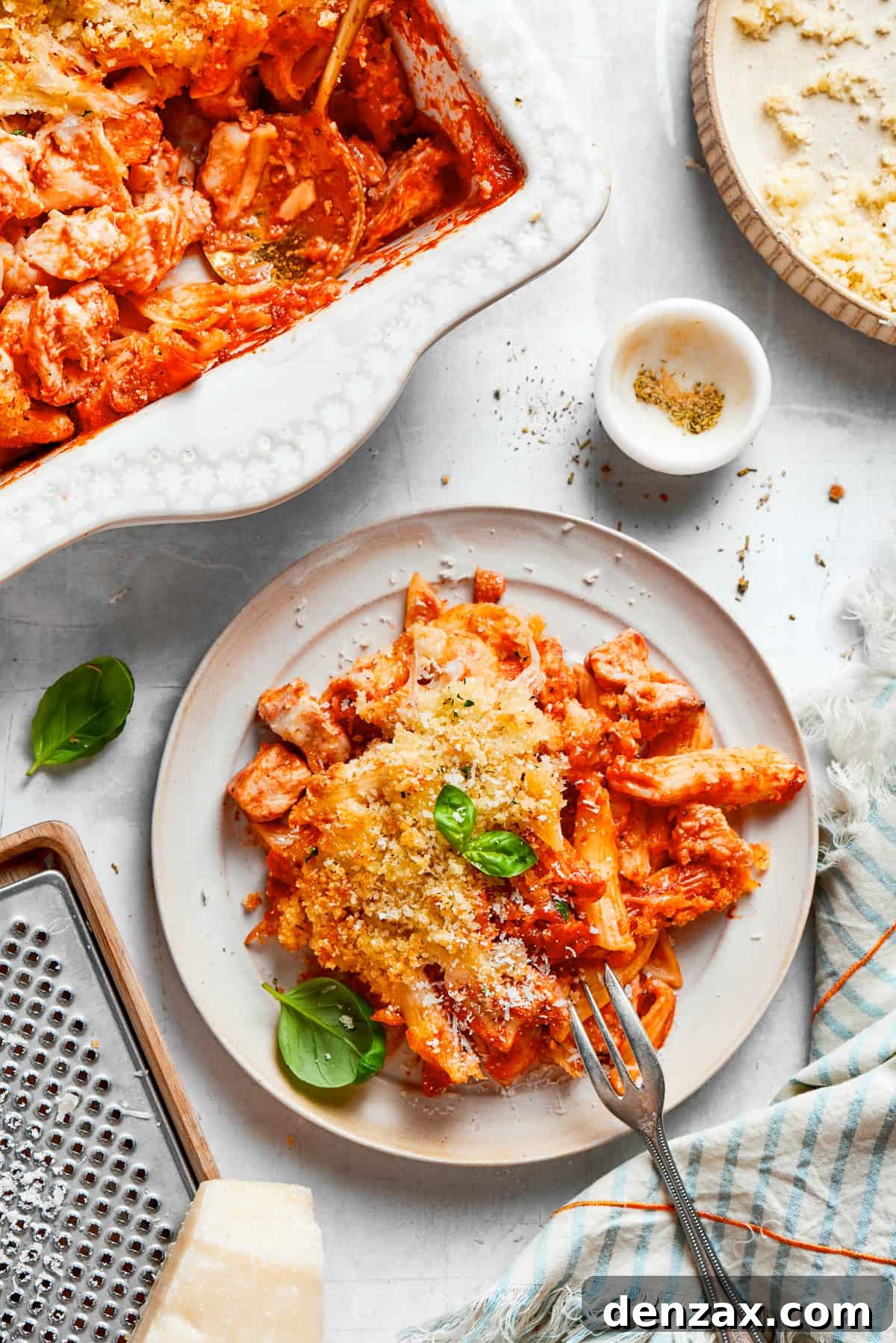 A plate of chicken parmesan casserole with a fork.