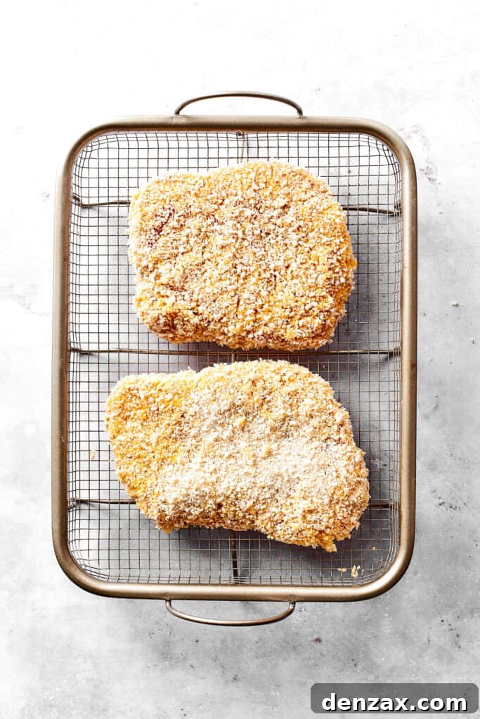 Breaded pork arranged on a wire rack.