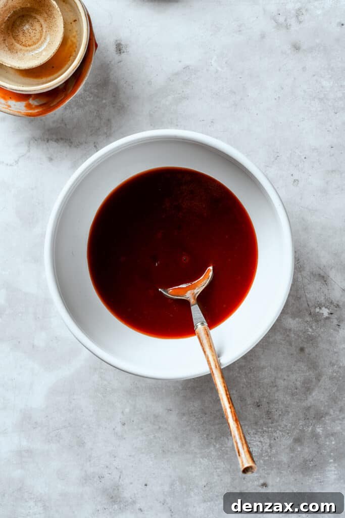 Tonkatsu sauce is stirred in a bowl.