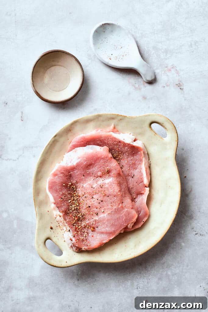Pork cutlets seasoned with salt and pepper.