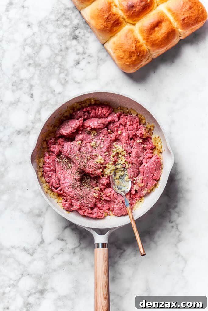 Brown the ground beef. Meat is added to the skillet.