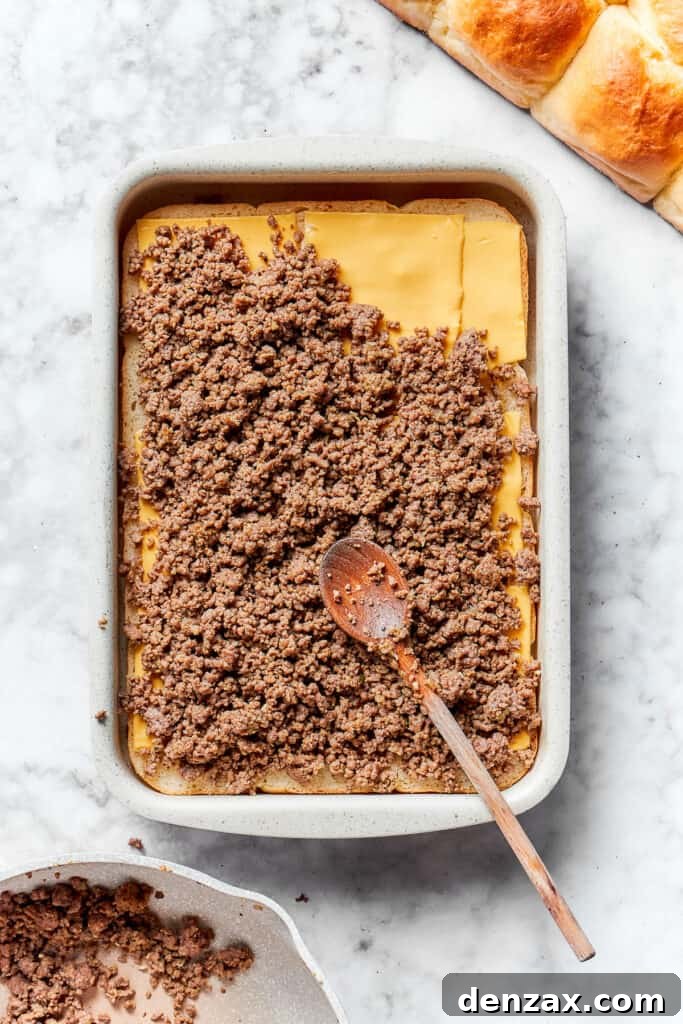 Spread beef over cheese. The beef mixture is added.