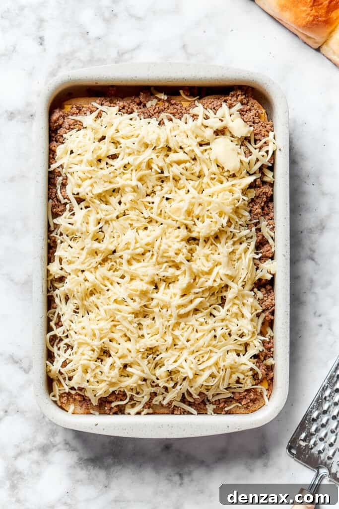 Top with shredded cheese. Shredded cheese tops the meat.