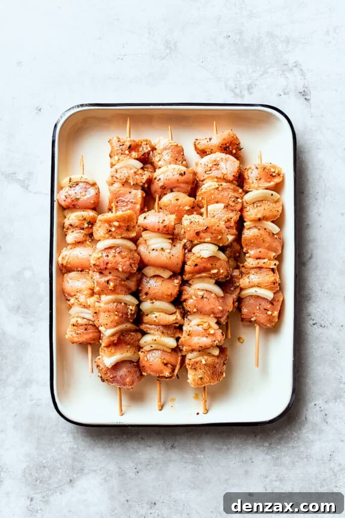 The chicken is threaded onto skewers.