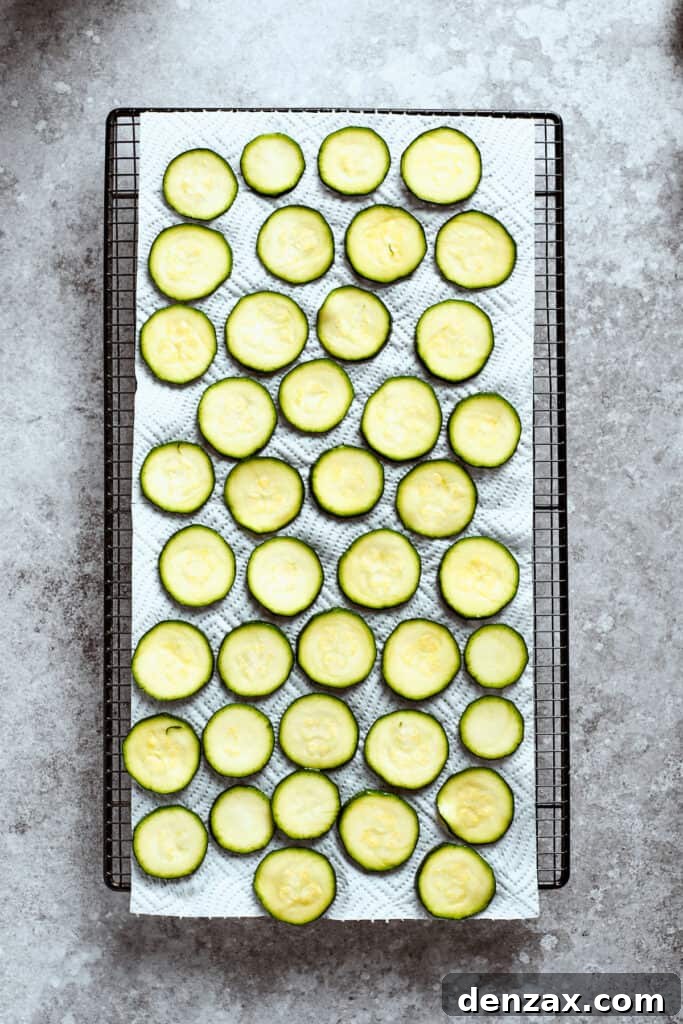 A large baking sheet full of slices of zucchini.
