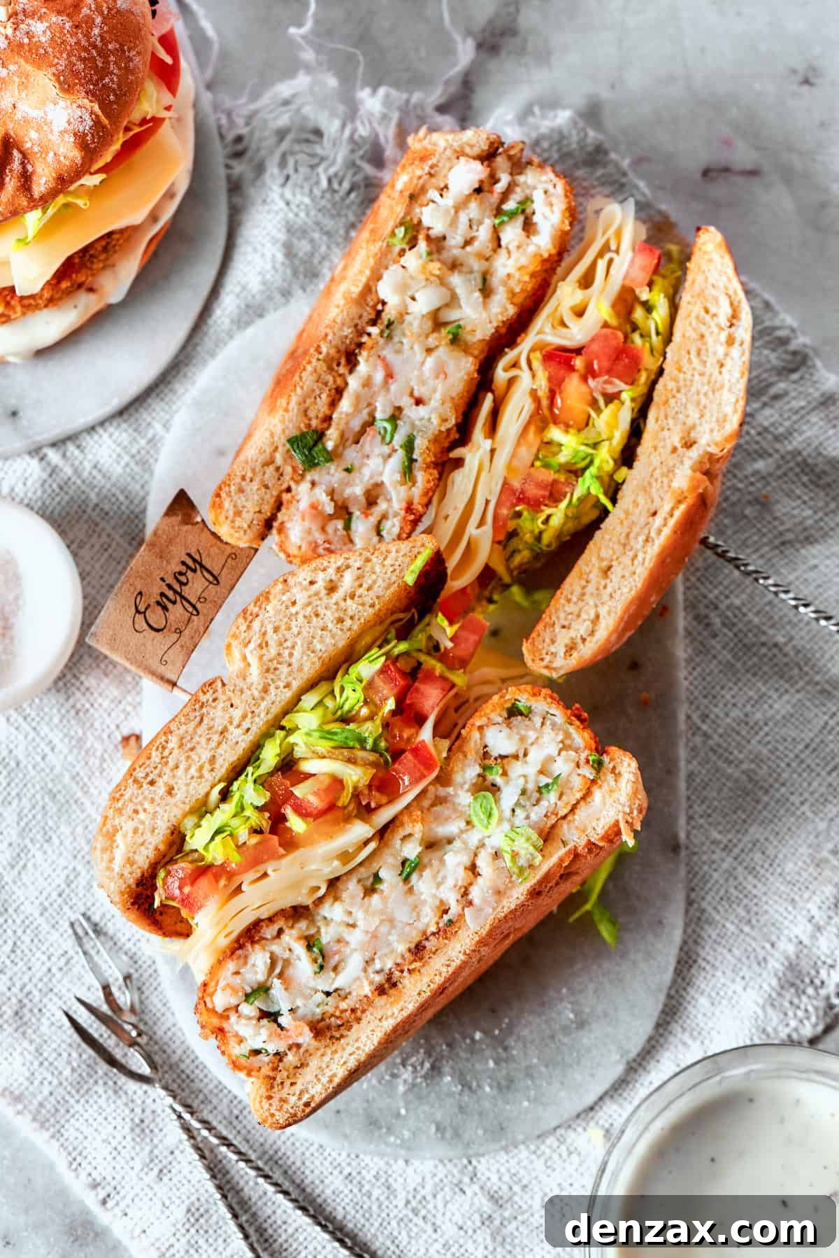 Two shrimp burger halves are turned on their sides.