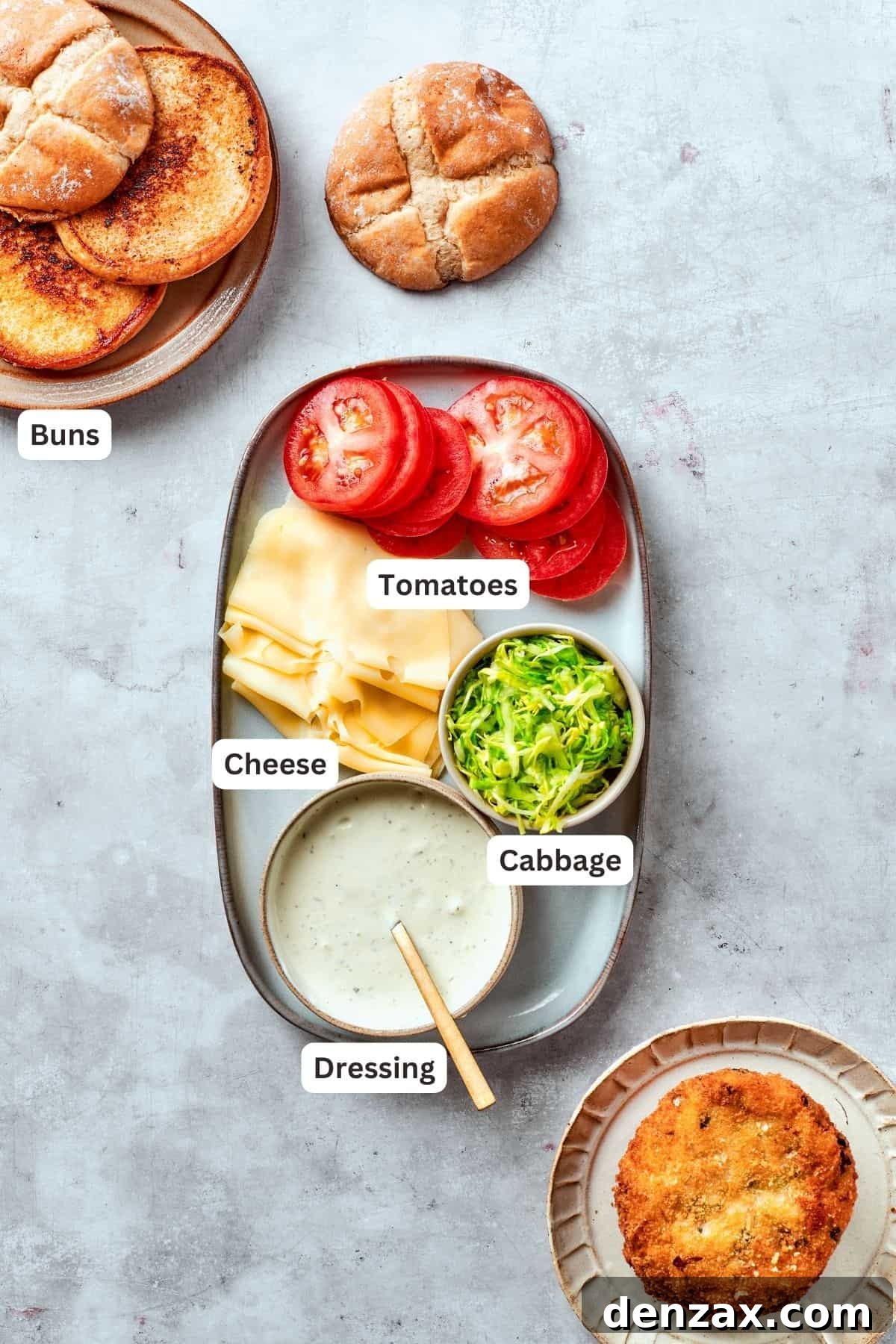 Ingredients for shrimp burgers assembly are shown labelled: buns, tomatoes, cabbage, dressing.
