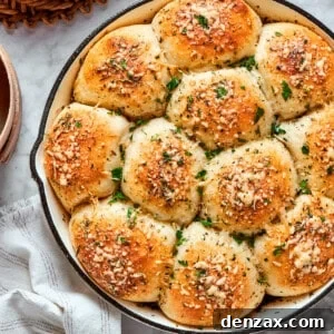 A skillet of baked pizza bites next to a bowl of sauce.