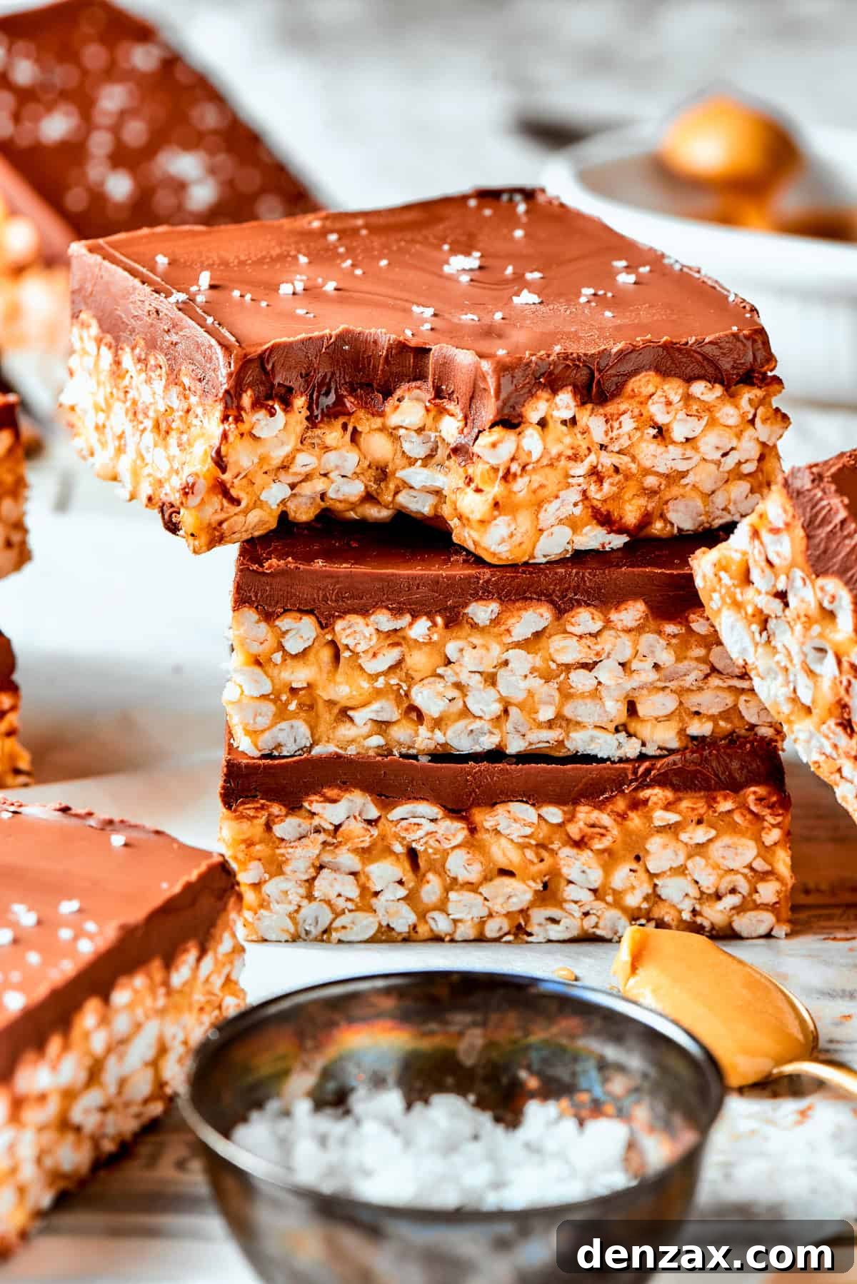 Peanut Butter Rice Crispy Treats A stack of rice crispy treats and the top one has a bite taken out of it.