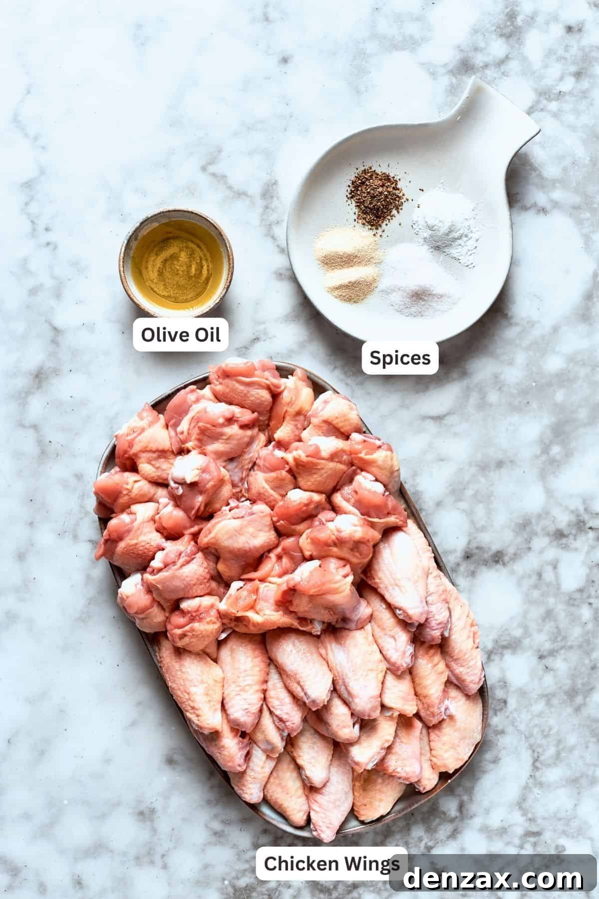 Ingredients for buffalo wings are labeled and portioned: chicken, olive oil, spices, baking powder.