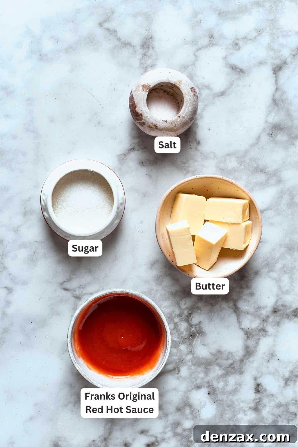 Ingredients for buffalo wings sauce are labeled and portioned: butter, sugar, salt, hot sauce.