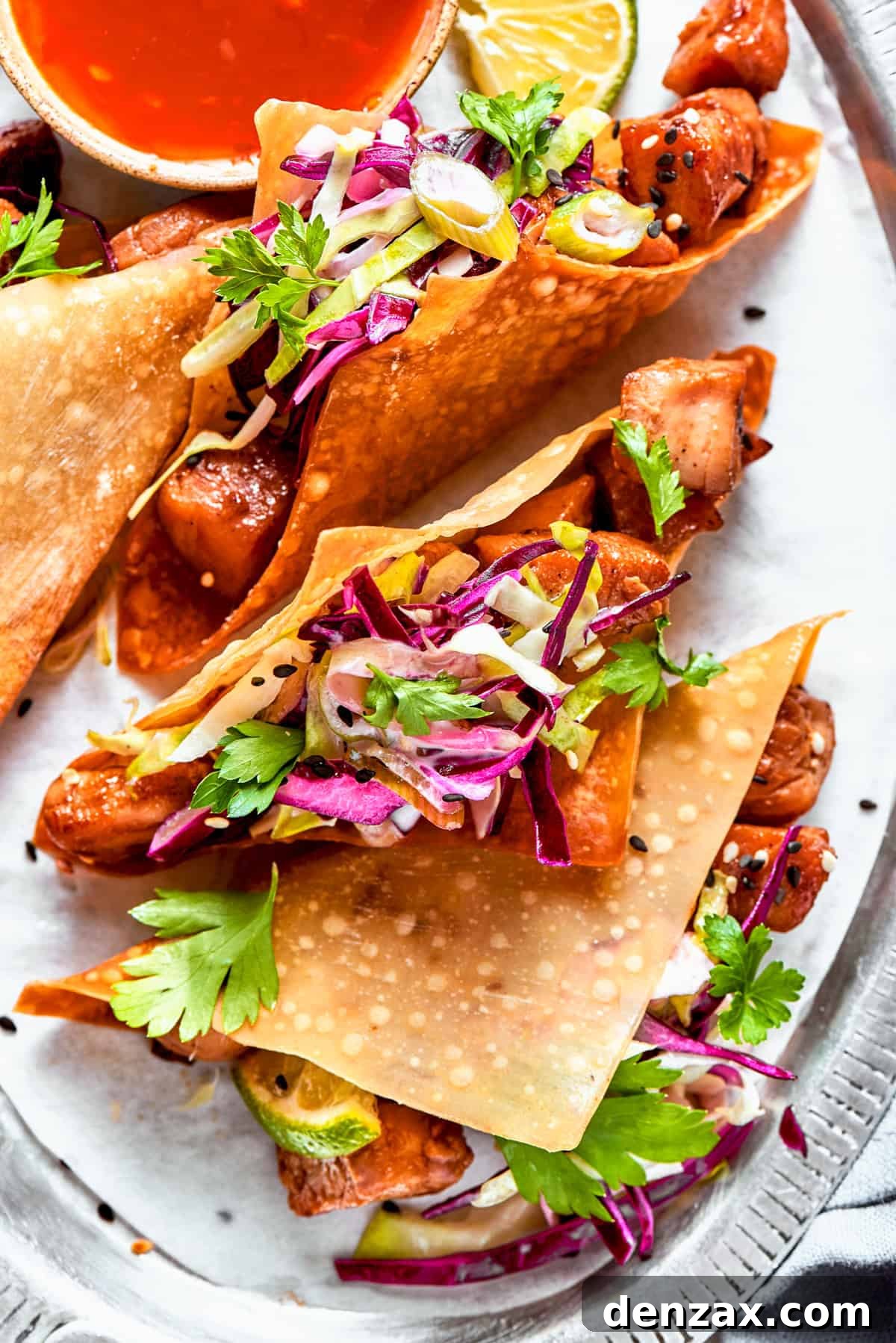 Overhead image of wonton tacos stuffed with cooked chicken and coleslaw.