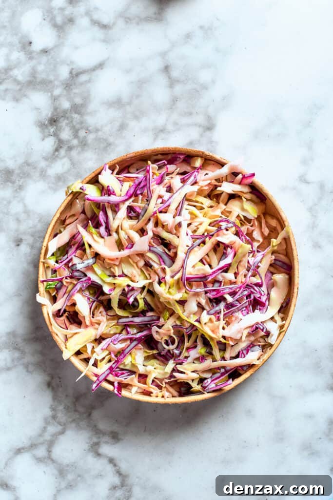 The sauce is combined with the coleslaw mix.