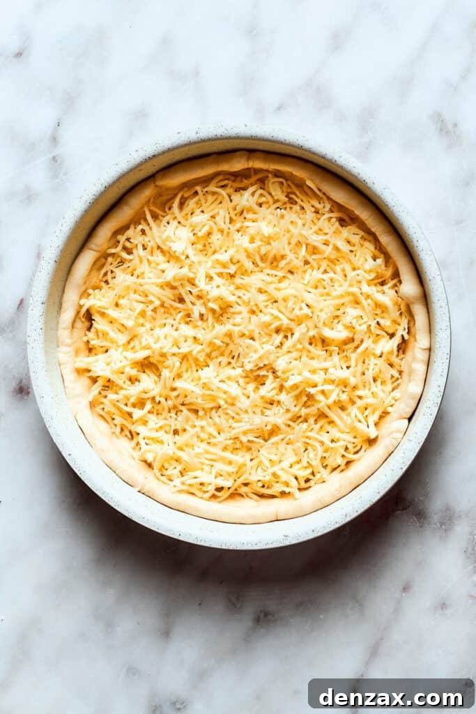 Cheese is added to the pizza.