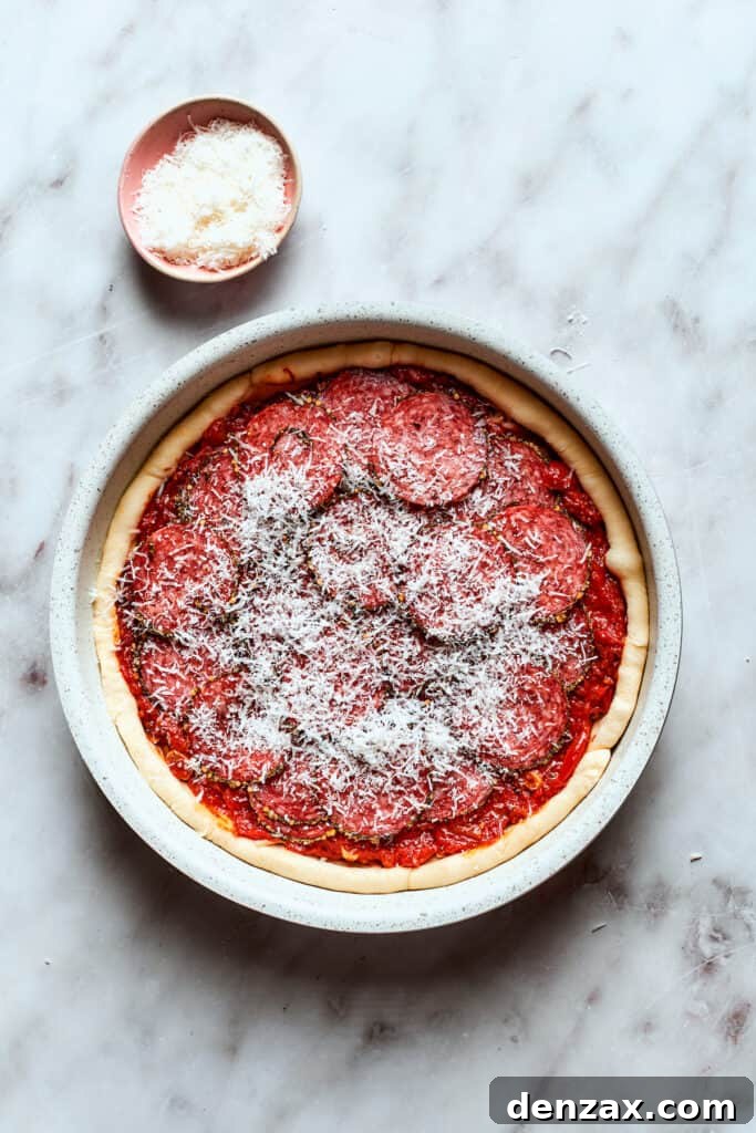 Parmesan cheese is scattered over the top of the pizza.