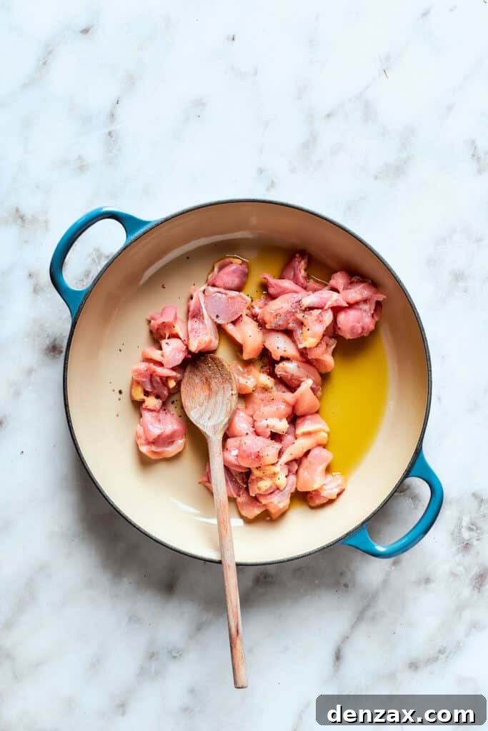 Chicken cooking in a pot.