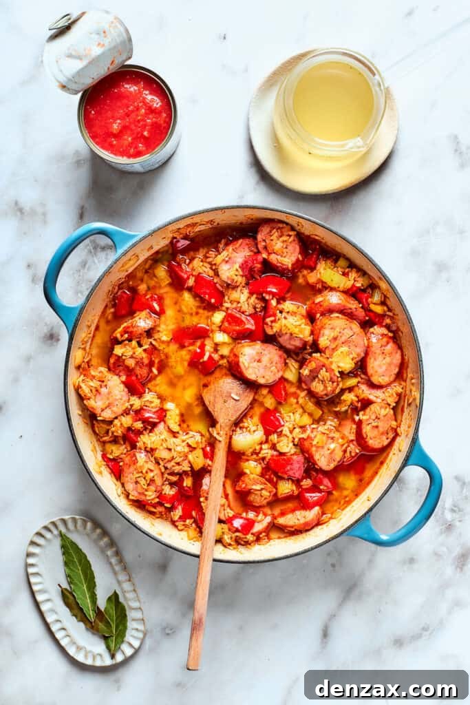 Wooden spoon stirring jambalaya.