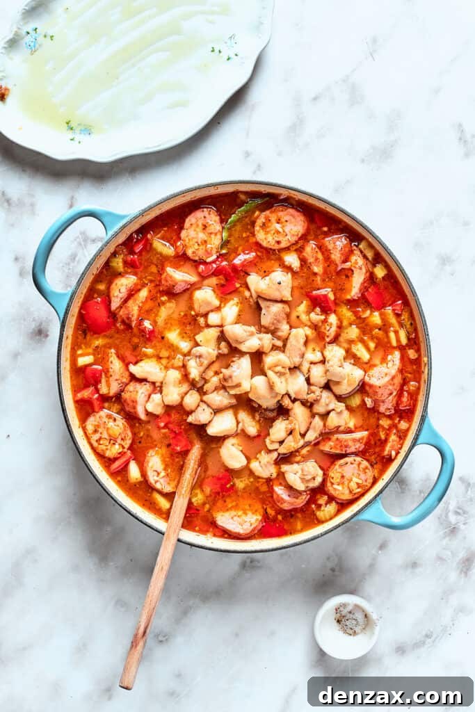 Chicken stirred back into jambalaya.