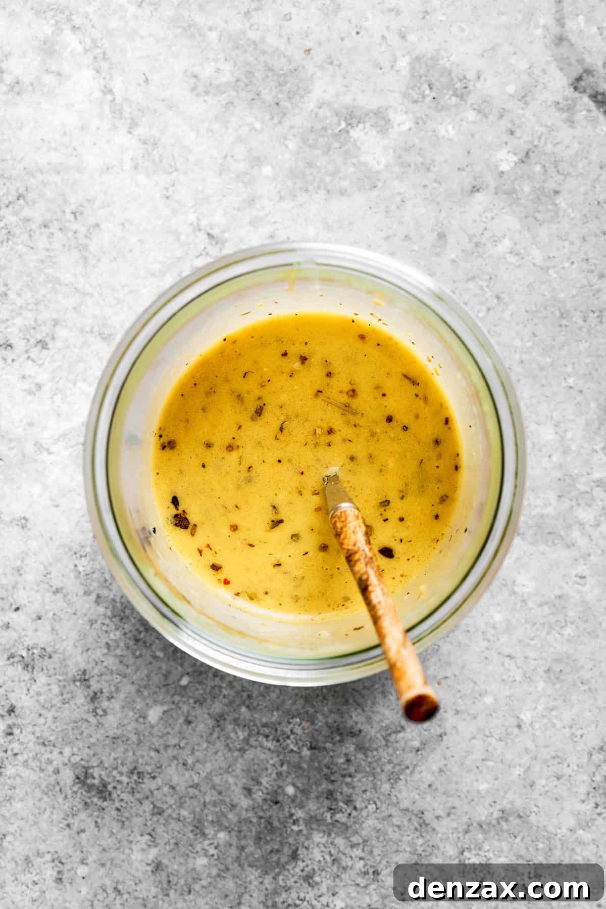 The dressing is mixed in a bowl.