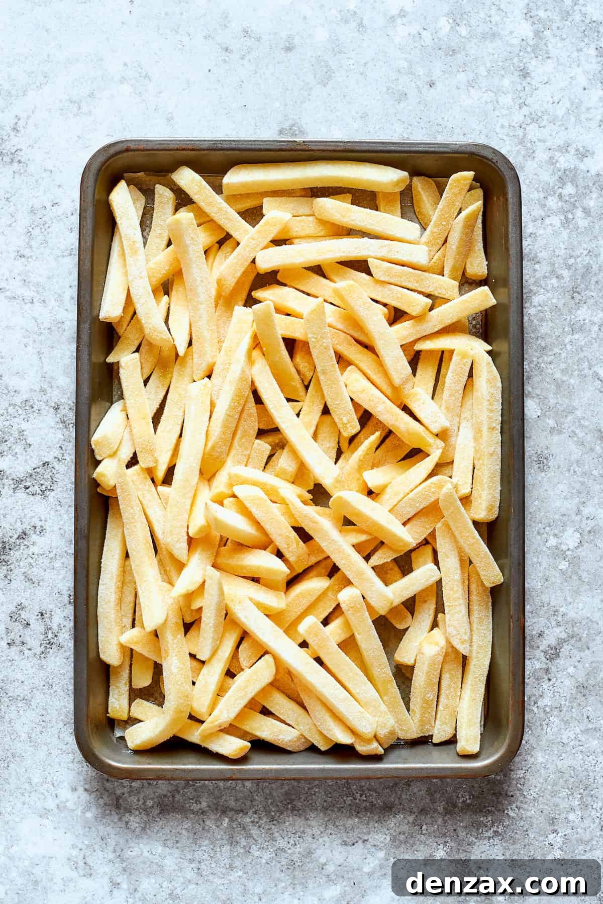French fries are cooked on a baking sheet.