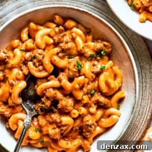 A bowl of macaroni tossed with beef sauce.