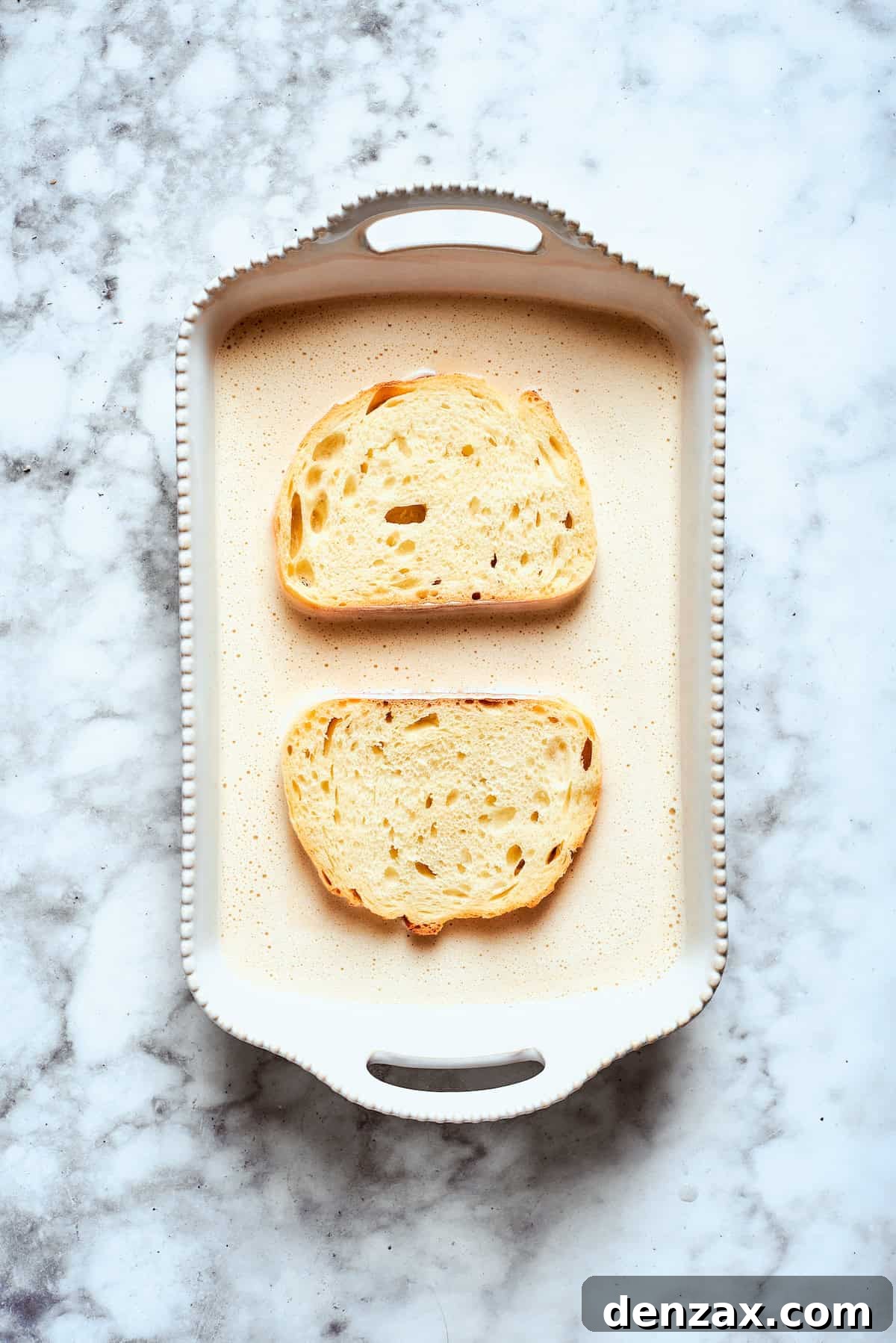 Bread slices soaking up banana batter.