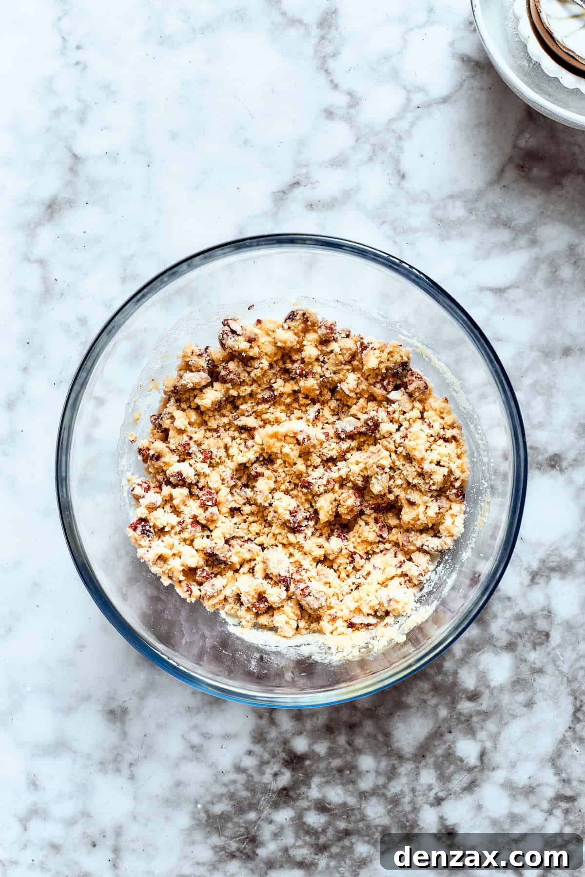 1. Make the pecan crust. Crust ingredients are added to a glass bowl.