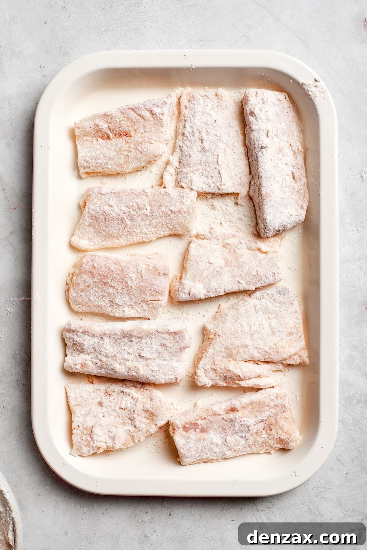 Pieces of fish on a baking tray.