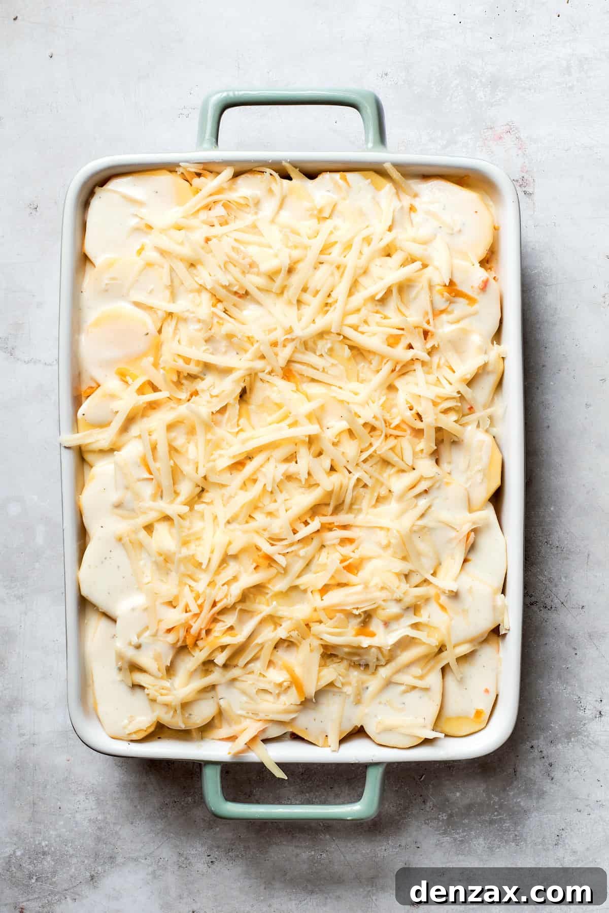 Cheese is added to the top of the casserole,