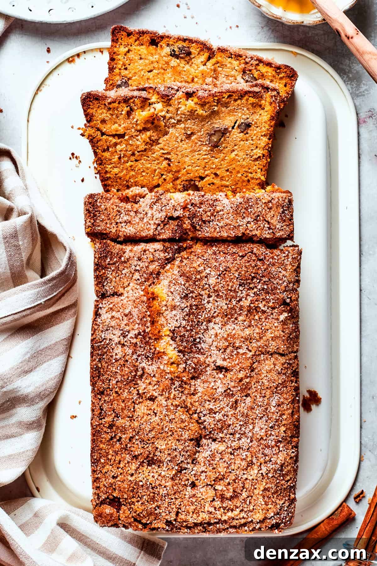 A loaf of Amish friendship bread is sliced on a cutting board.
