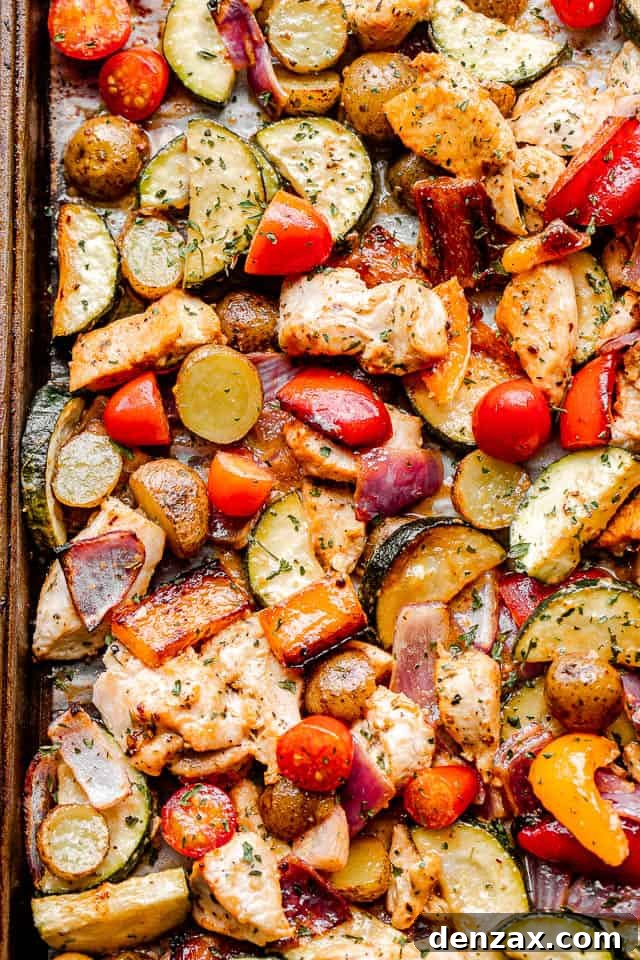Sheet Pan Chicken with Roasted Vegetables Dinner 2 top close up shot of cooked chicken and vegetables on a sheet pan