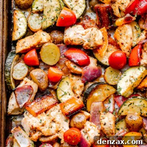 Sheet Pan Chicken with Roasted Vegetables Dinner 5 top close up shot of cooked chicken and vegetables on a sheet pan