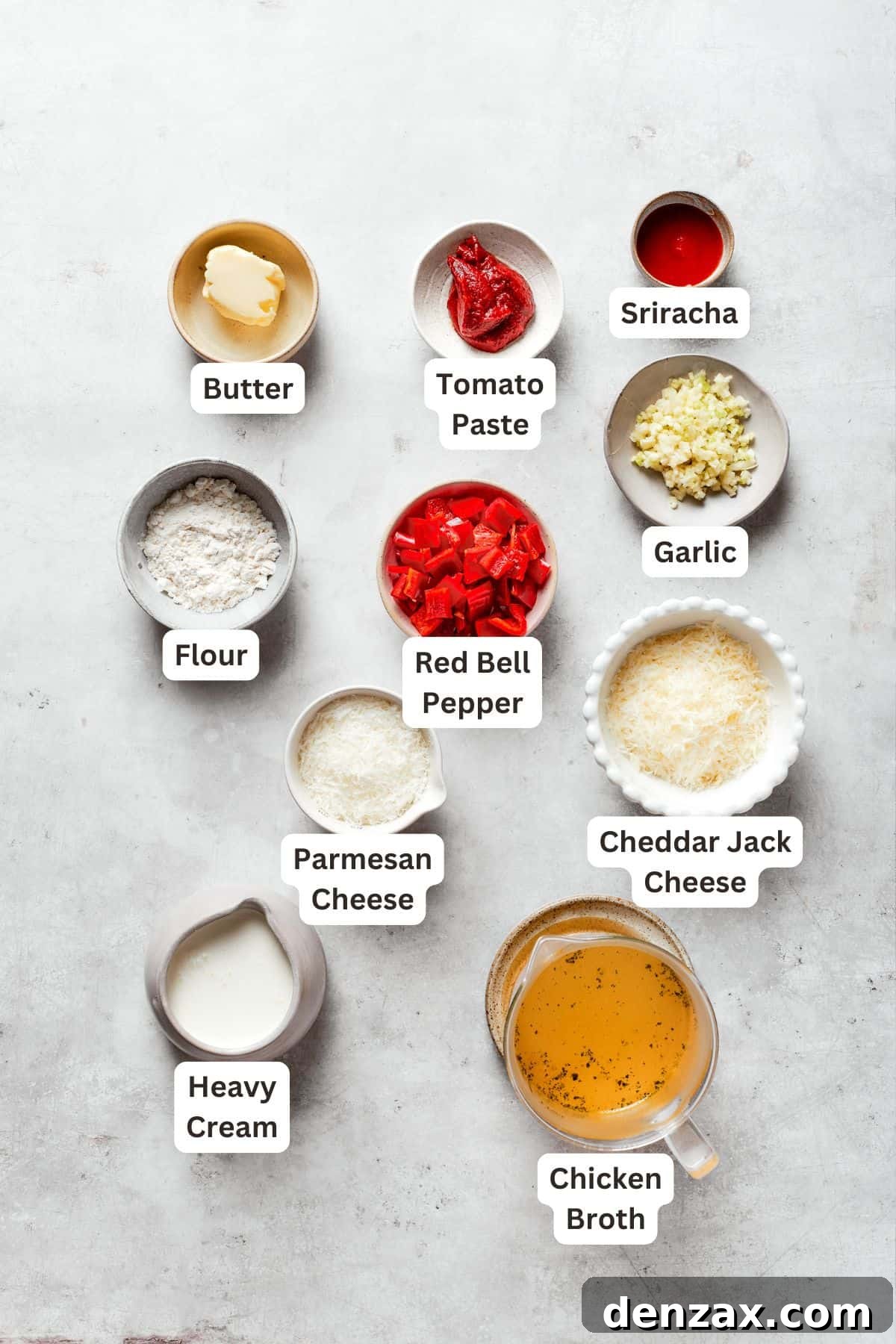 Labeled ingredients for cajun shrimp sauce include butter, tomato paste, garlic, sriracha, cheddar jack cheese, parmesan cheese, heavy cream, chicken broth.